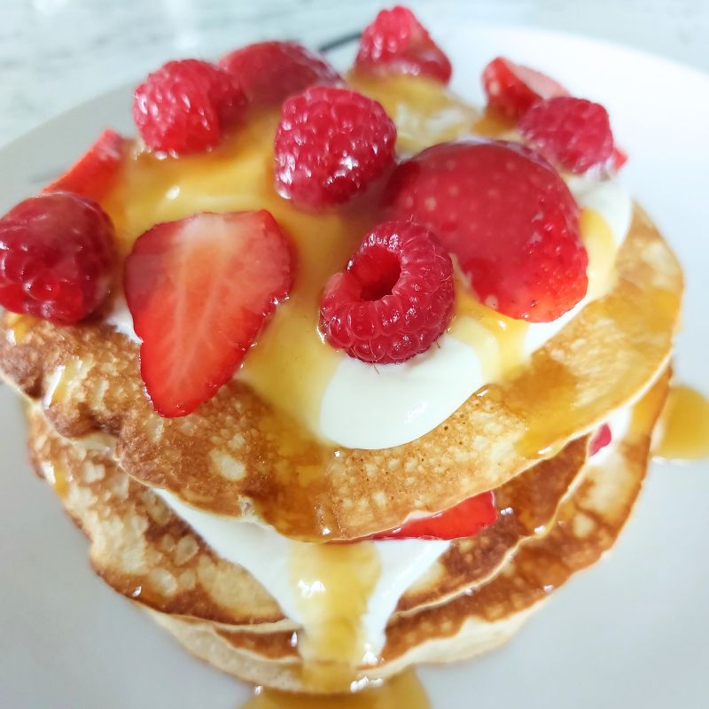 Pancakes with summer berries, greek yogurt & salted caramel sauce